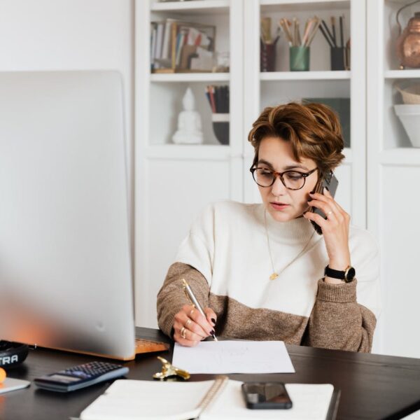 modern businesswoman in casual outfit talking on mobile in office